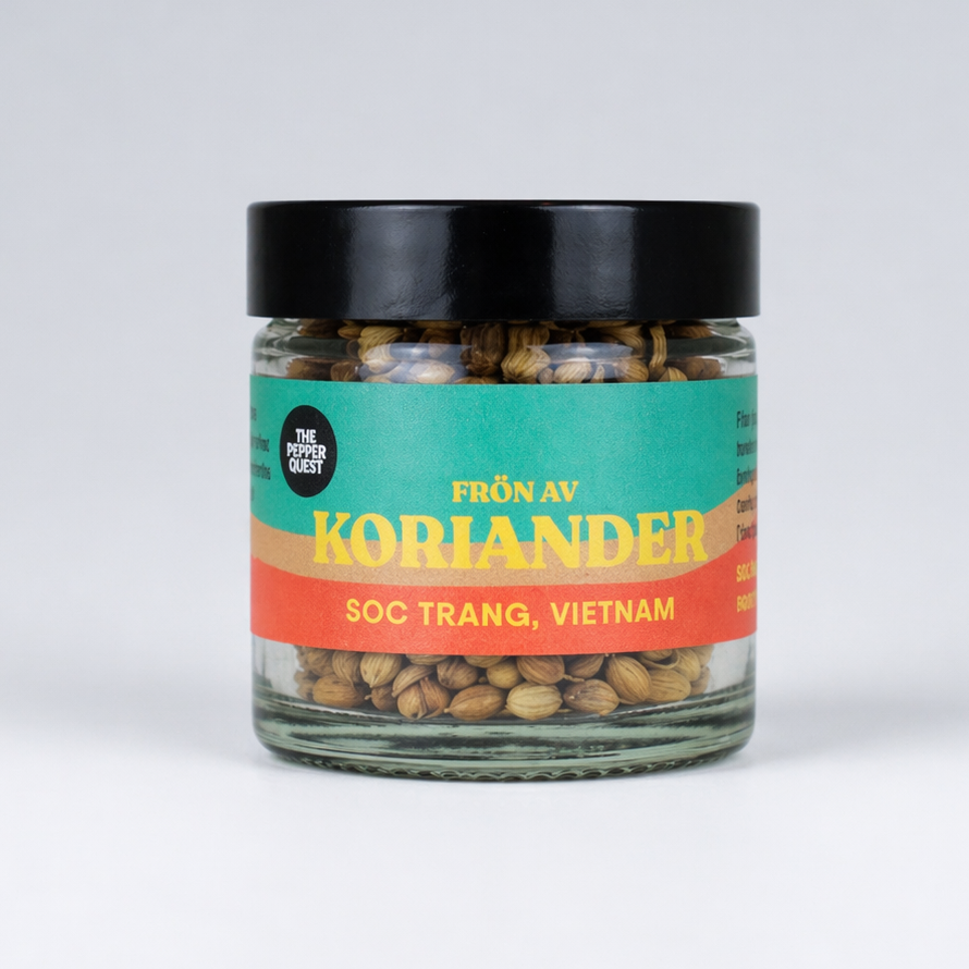 Jar of coriander seeds with a colorful label on a white background