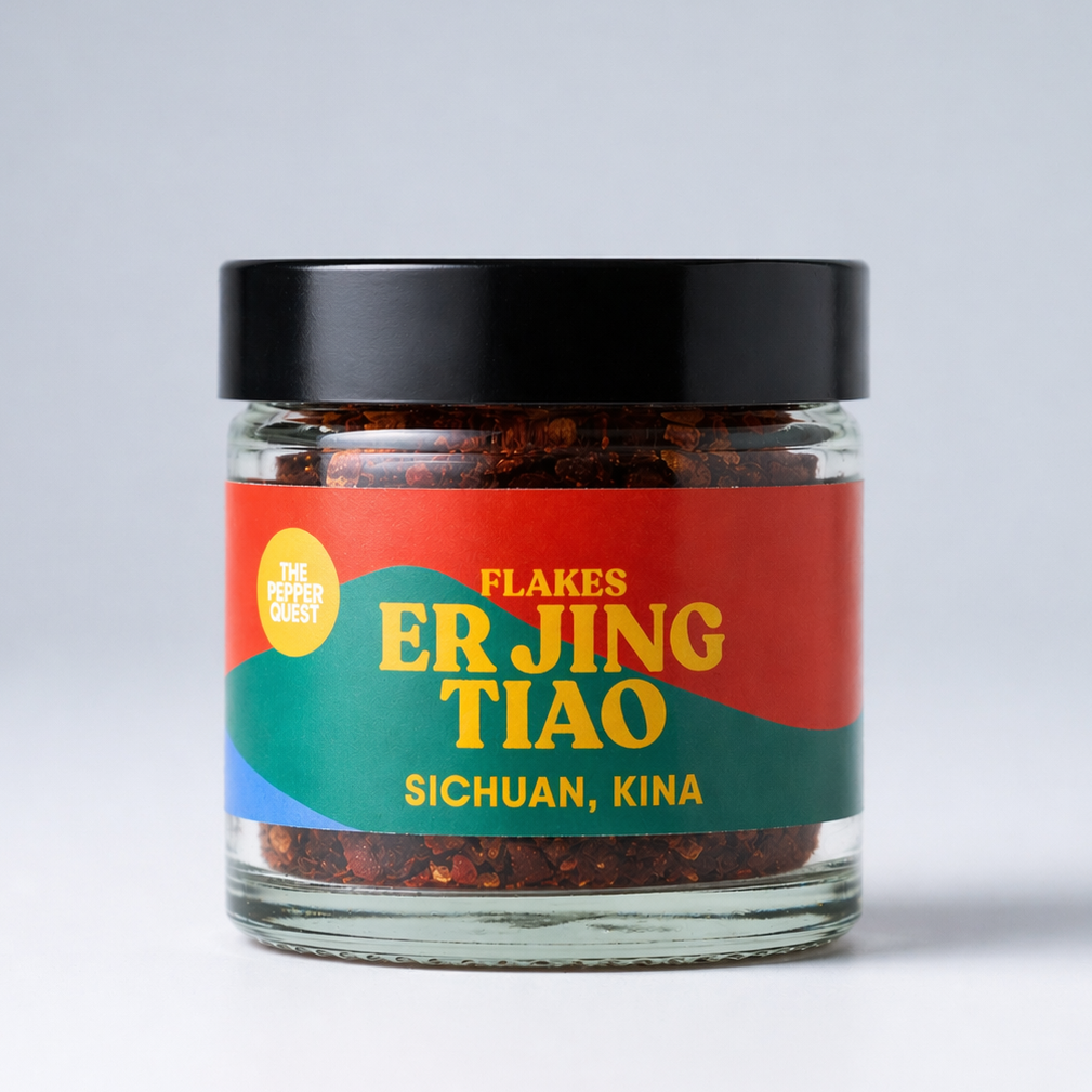 Jar of Er Jing Tiao flakes with colorful label on a white background
