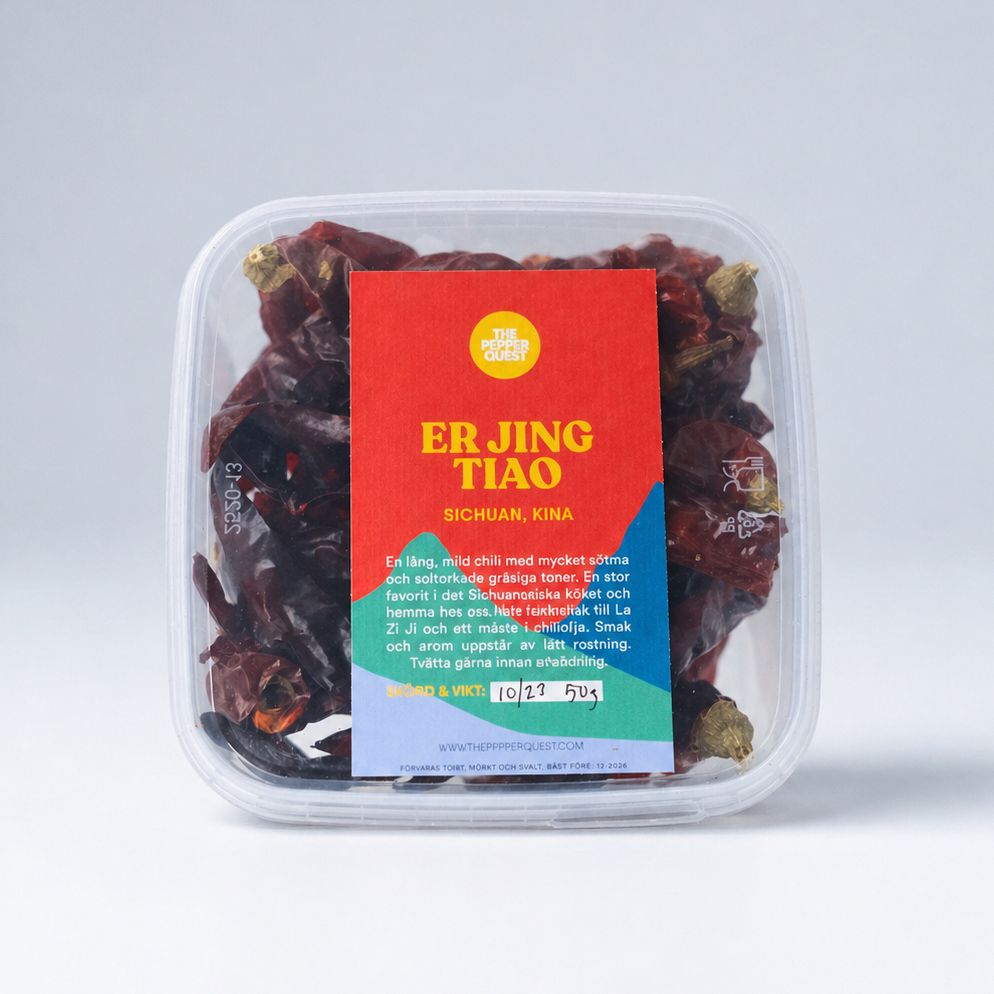 Packaged dried red chilies with a colorful label on a white background