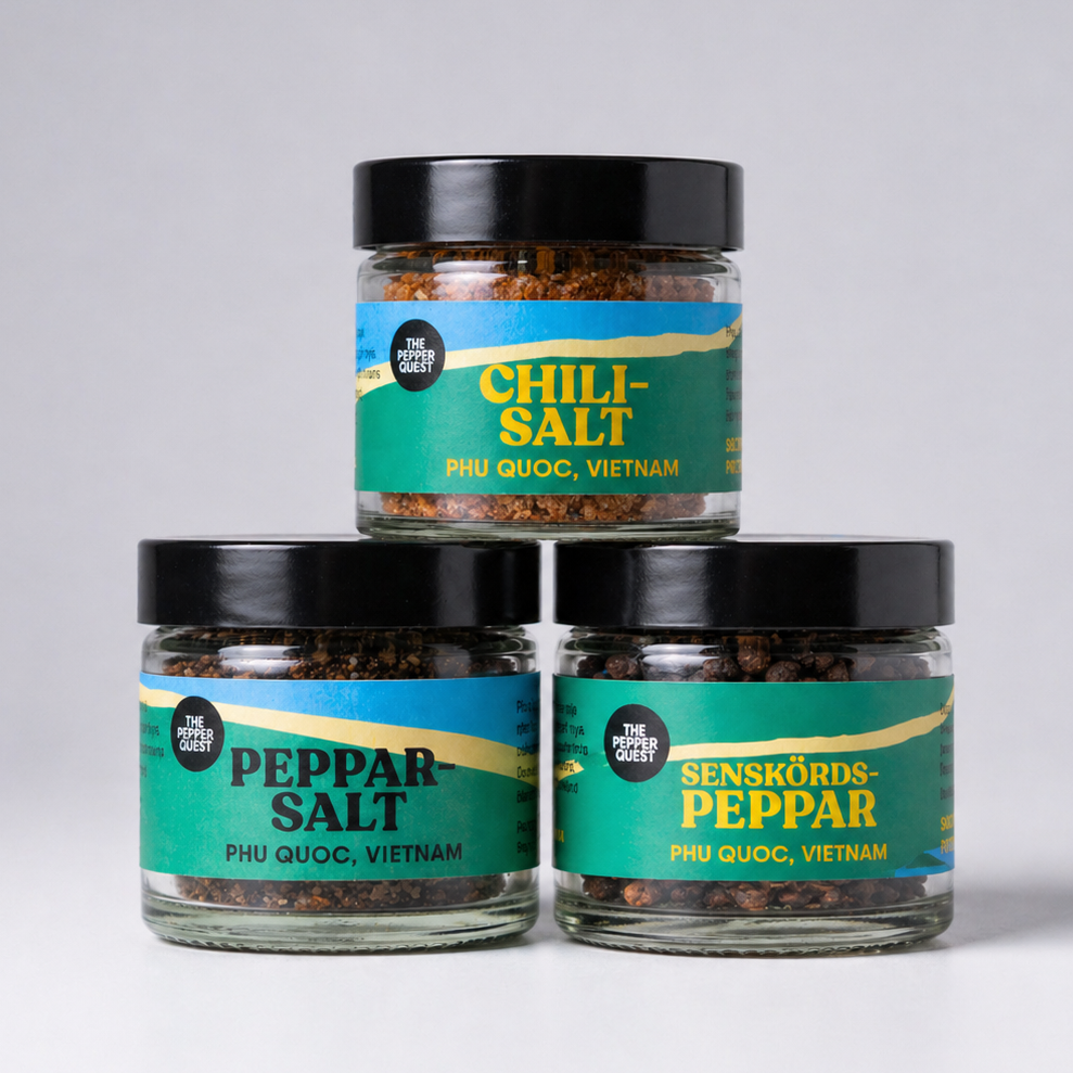 Three jars of pepper and salt with labels on a light gray background