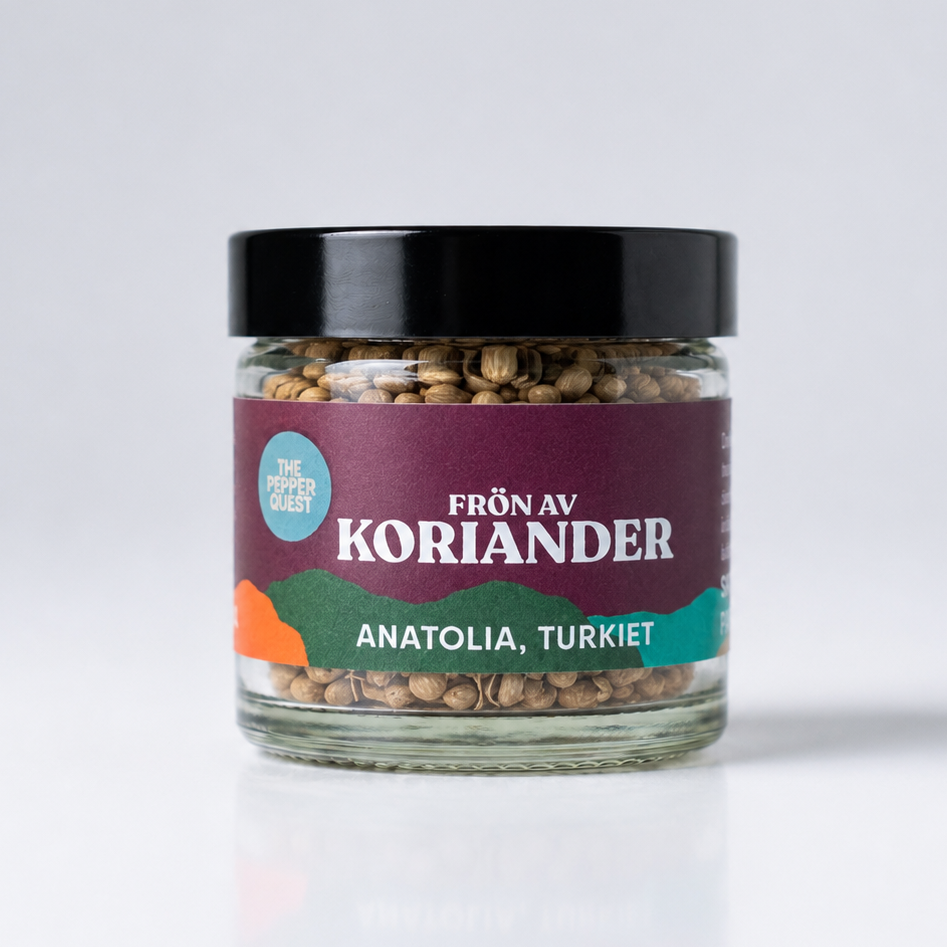 Jar of coriander seeds with a label on a white background