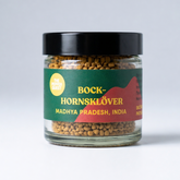 Jar of Fenugreek with a green label on a white background