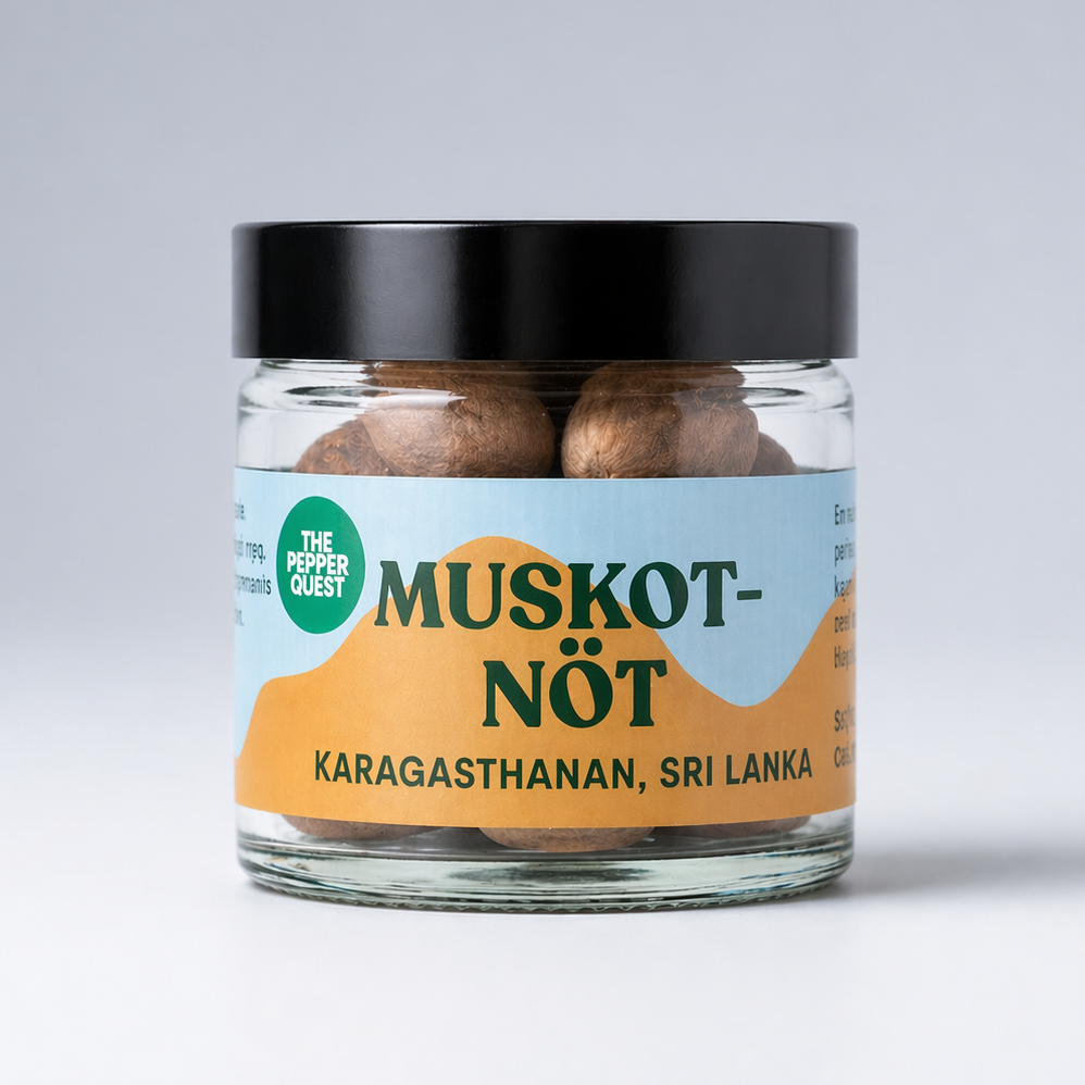 Jar of Nutmeg with a black lid on a light gray background